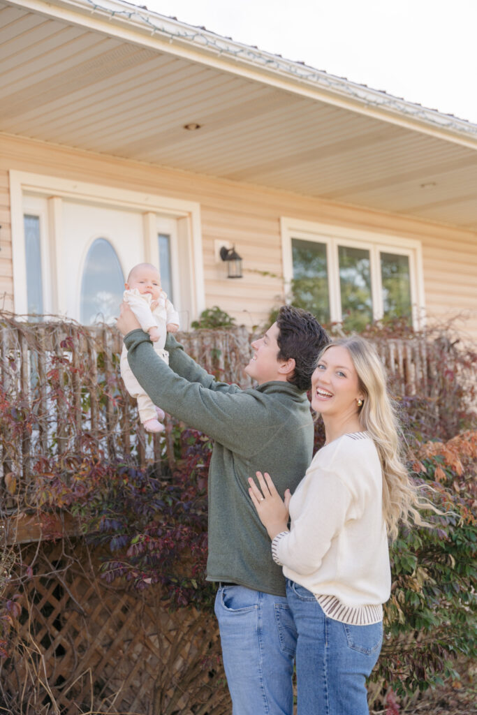 candid photo of mom and dad with baby girl 