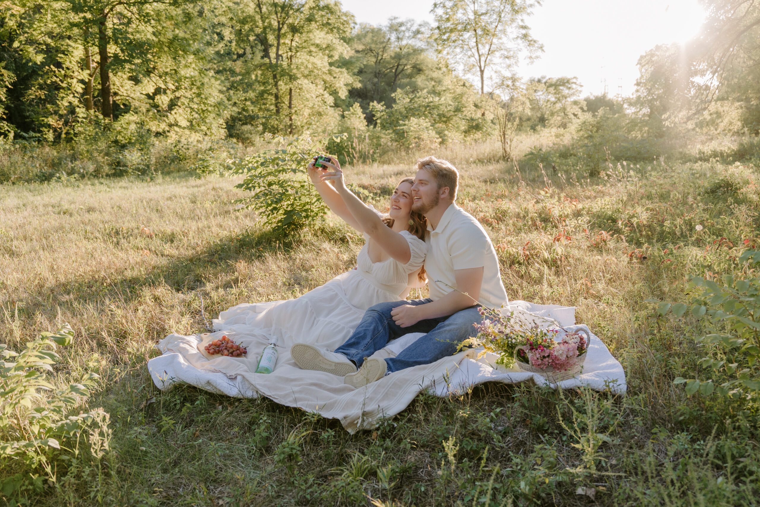 engagement session with couple on a blanket at sunset